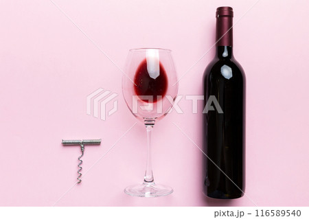 Flat lay composition with corkscrew, bottle of wine and elegant glass on colored table. Flat lay, top view wth copy space 116589540