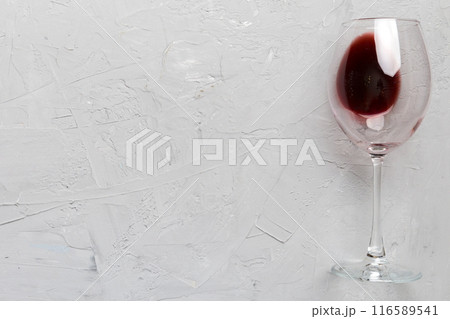 One glasses of red wine at wine tasting. Concept of red wine on colored background. Top view, flat lay design 116589541