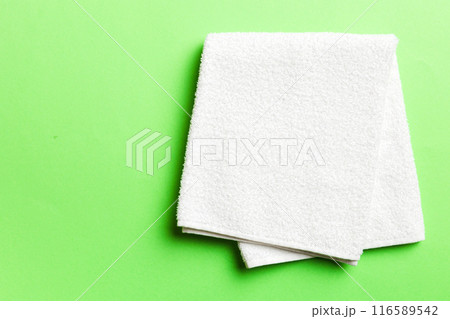 Top view of white towels with copy space on colored background 116589542