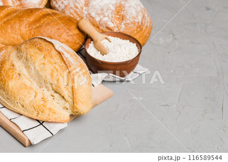 Homemade natural breads. Different kinds of fresh bread as background, perspective view with copy space 116589544