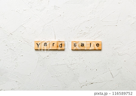 Yard sale word written on wood block. Yard sale text on cement table for your desing, Top view concept Yard sale word written on wood block. Yard sale text on cement table for your desing, Top view concept 116589752