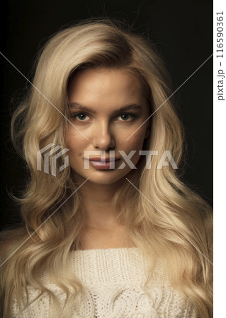 Studio photo portrait of a young pretty blonde on a dark background, close-up portrait of a woman Studio photo portrait of a young pretty blonde on a dark background, close-up portrait of a woman 116590361
