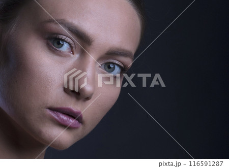 portrait of a young beautiful woman on a dark background portrait of a young beautiful woman on a dark background 116591287