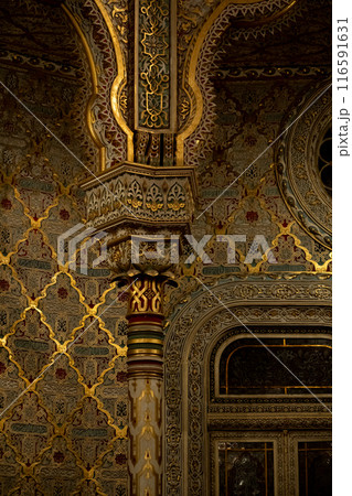 The building is ornate with columns, windows, wood art, and symmetry 116591631