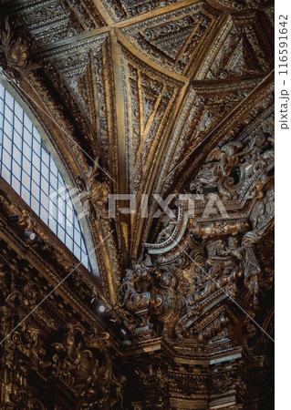 A close up of a carved wooden ceiling with a window, an architectural detail A close up of a carved wooden ceiling with a window, an architectural detail 116591642