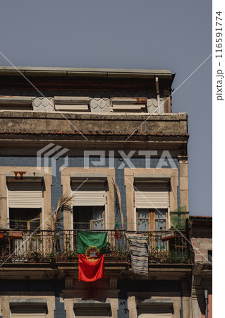 The image shows a building with a flag displayed from the balcony The image shows a building with a flag displayed from the balcony 116591774
