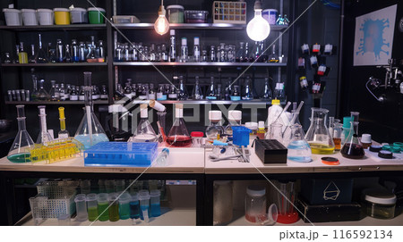 Science laboratory setup with test tubes, beakers, microscopes, chemical bottles 116592134