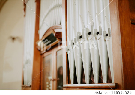 Selective focus shot of part of pipe organ instrument in Catholic cathedral interior, copy space 116592529