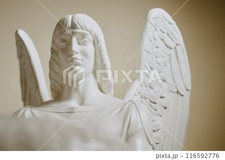 Medium closeup of gypsum sculpture of angel in catholic church interior Medium closeup of gypsum sculpture of angel in catholic church interior 116592776