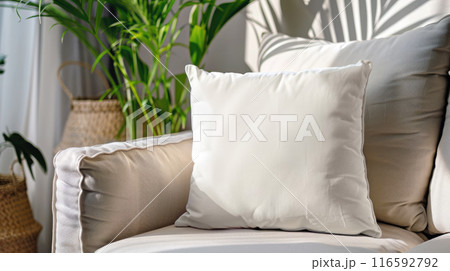 Blank white pillow on a couch. Closeup mockup template. Cozy interior 116592792