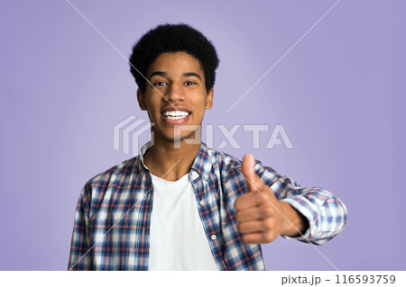Recommend you. Happy guy showing thumb up and smiling over pink background Recommend you. Happy guy showing thumb up and smiling over pink background 116593759