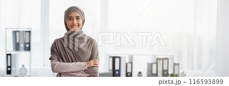 Business Career For Muslim Woman. Portrait Of Confident Arabic Businesswoman In Hijab Standing With Folded Arms Near Her Workplace In Office, Copy Space Business Career For Muslim Woman. Portrait Of Confident Arabic Businesswoman In Hijab Standing With Folded Arms Near Her Workplace In Office, Copy Space 116593899