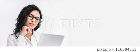 Office Person. Beautiful hispanic businesswoman using digital tablet working at modern office, vertical image, panorama with copy space Office Person. Beautiful hispanic businesswoman using digital tablet working at modern office, vertical image, panorama with copy space 116594513