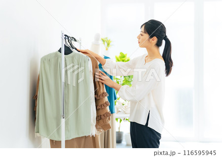 アパレルショップで商品を陳列する女性店員 116595945