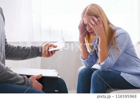 Professional psychotherapist with clipboard giving paper tissues to upset crying patient, panorama Professional psychotherapist with clipboard giving paper tissues to upset crying patient, panorama 116595968