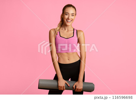 Fitness Concept. Young Woman Holding Gym Mat Smiling At Camera On Yellow Studio Background. 116596698