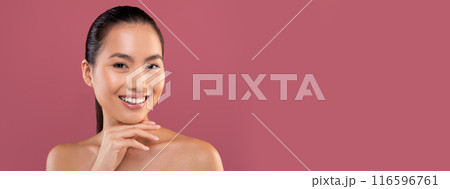 Closeup portrait of beautiful topless young chinese woman posing on purple studio background, touching her chin and smiling at camera, enjoying her smooth glow face skin, copy space Closeup portrait of beautiful topless young chinese woman posing on purple studio background, touching her chin and smiling at camera, enjoying her smooth glow face skin, copy space 116596761