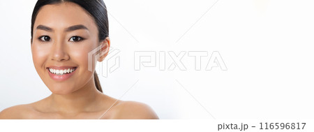 Half-naked young pretty asian woman posing over white studio background, smiling at camera, panorama with copy space 116596817