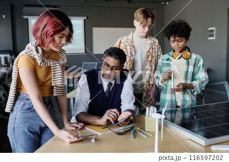 Group of ethnically diverse students learning about renewable energy technologies during lesson at school 116597202
