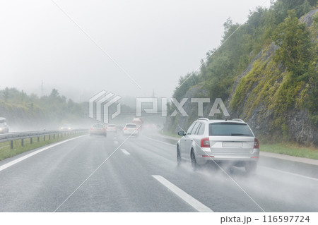 Back tail view of many cars driving fast on wet highway road after rain in Europe. Automobile accident vehicle rush hour collapse. Transportation vacation seasonal stuck Back tail view of many cars driving fast on wet highway road after rain in Europe. Automobile accident vehicle rush hour collapse. Transportation vacation seasonal stuck 116597724