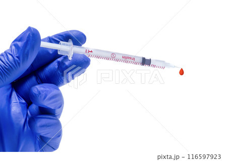 doctor or nurse holding a syringe with a drop of blood in the needle on a white background. closeup doctor or nurse holding a syringe with a drop of blood in the needle on a white background. closeup 116597923
