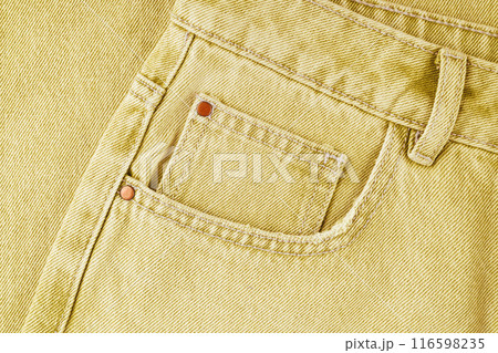 Front pocket, small pocket, details of yellow jeans pants close up, macro Front pocket, small pocket, details of yellow jeans pants close up, macro 116598235