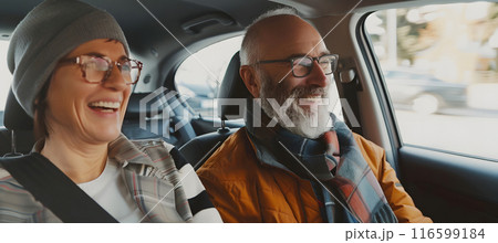 Man and woman in back seat of taxi. positive middle-aged couple rides in a taxi 116599184