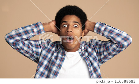 Wow. Guy with surpised expression looking at camera over white background Wow. Guy with surpised expression looking at camera over white background 116599683