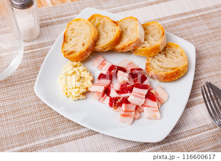 Snack for vodka, homemade salo with bread and horseradish on rustic board Snack for vodka, homemade salo with bread and horseradish on rustic board 116600617