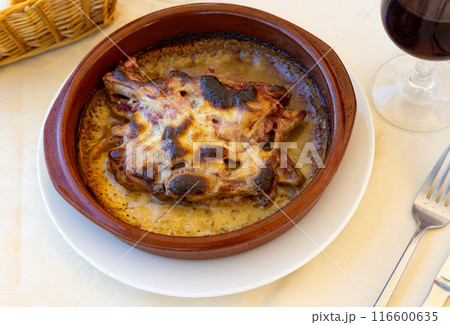 Appetizing pork leg in mushroom sauce on dinner table 116600635