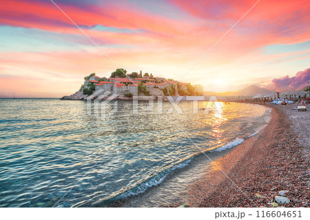 Captivating sunset view of luxury beach and islet Sveti Stefan near Budva. 116604651