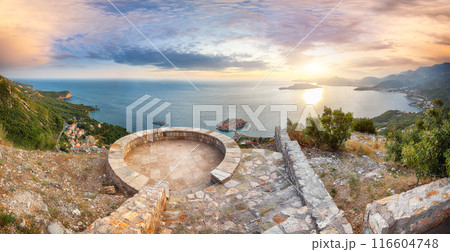 Captivating sunset view of Adriatic coast and islet Sveti Stefan from church st. Sava viewpoint near Budwa 116604748