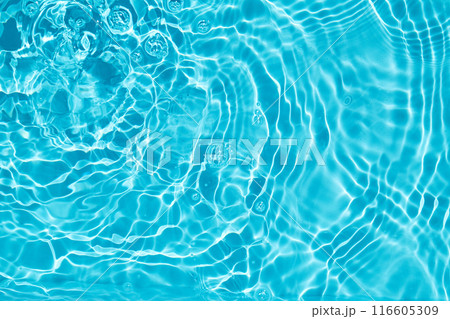 Rippling Water Surface. A calming image of rippling blue water with light reflections. 116605309