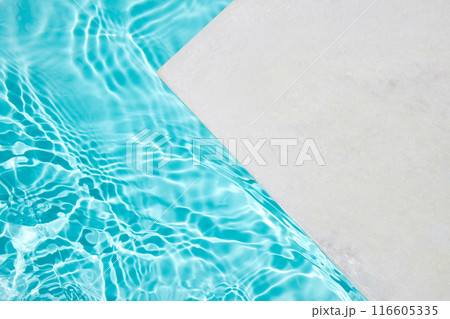 Poolside Serenity. A serene poolside scene with clear, rippling turquoise water 116605335