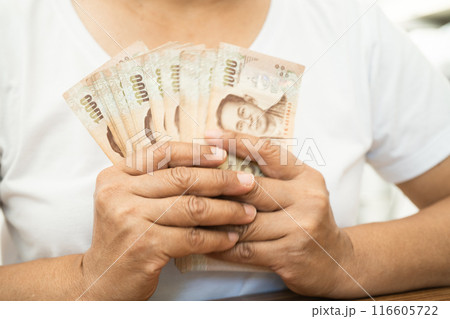 Asian business woman holding Thai banknote currency money. Asian business woman holding Thai banknote currency money. 116605722