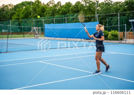 Professional female tennis player playing the tennis on outside court 116606111