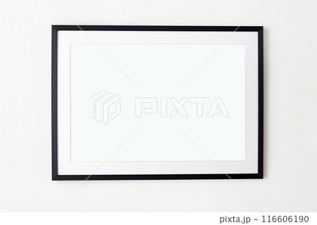 big black picture frame on white wall. Stylish photoframe with passe-partout big black picture frame on white wall. Stylish photoframe with passe-partout 116606190