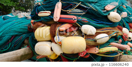 Fishing gear, nets, and floats are dried on the shore. Fishing gear, nets, and floats are dried on the shore. 116606240