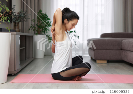 Back view of sporty woman stretching hands and warm up arm for exercise at home Back view of sporty woman stretching hands and warm up arm for exercise at home 116606525