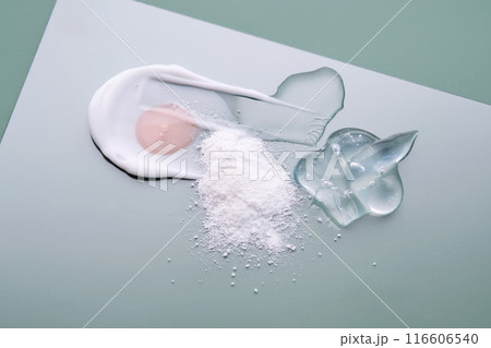 Textures of different cosmetic products on a green background. 116606540