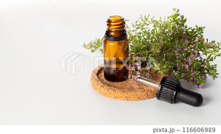Fresh thyme and essential oil on the white background. Hair treatment concept. Close up 116606989