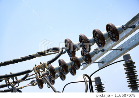 Close view of high voltage post, High voltage tower, show with high voltage construction and power lines, with blue sky background. 116607079