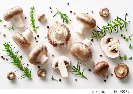 Composition of whole and sliced champignon mushrooms arranged alongside fresh herbs and aromatic spices on a clean white background. Appetizing culinary scene. Composition of whole and sliced champignon mushrooms arranged alongside fresh herbs and aromatic spices on a clean white background. Appetizing culinary scene. 116608027