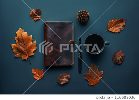 Masculine workspace flat lay with autumn leaves, brown leather notebook, pen, and coffee cup on aqua blue background. Great design with copy space. 116608036