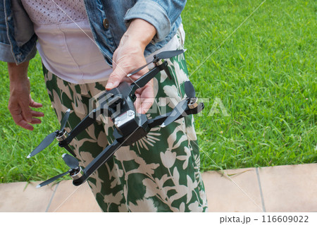 Unrecognizable caucasian woman holding a quadcopter outdoors 116609022