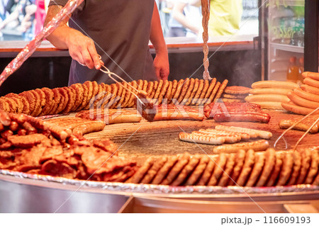 large grill filled with various types of german sausages 116609193