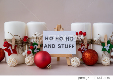 Message on greeting card HO HO HO AND STUFF text on paper note Traditional four advent weeks calendar before Christmas holidays. Candles and plastic free zero waste sustainable decoration. Greeting Message on greeting card HO HO HO AND STUFF text on paper note Traditional four advent weeks calendar before Christmas holidays. Candles and plastic free zero waste sustainable decoration. Greeting 116610230