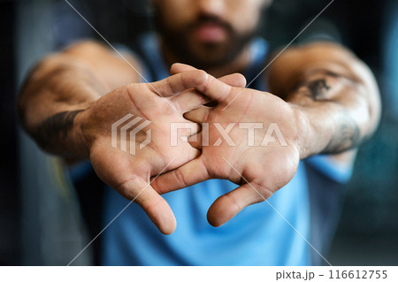 Man warming up his hands before workout training at gym, closeup Man warming up his hands before workout training at gym, closeup 116612755