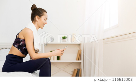 Millennial Girl Using Phone, Resting After Practicing Yoga At Home, Free Space 116613308