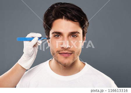 Cosmetic Operation. Portrait Of young man before plastic surgery, doctor hands with scalpel near patient's face Cosmetic Operation. Portrait Of young man before plastic surgery, doctor hands with scalpel near patient's face 116613316